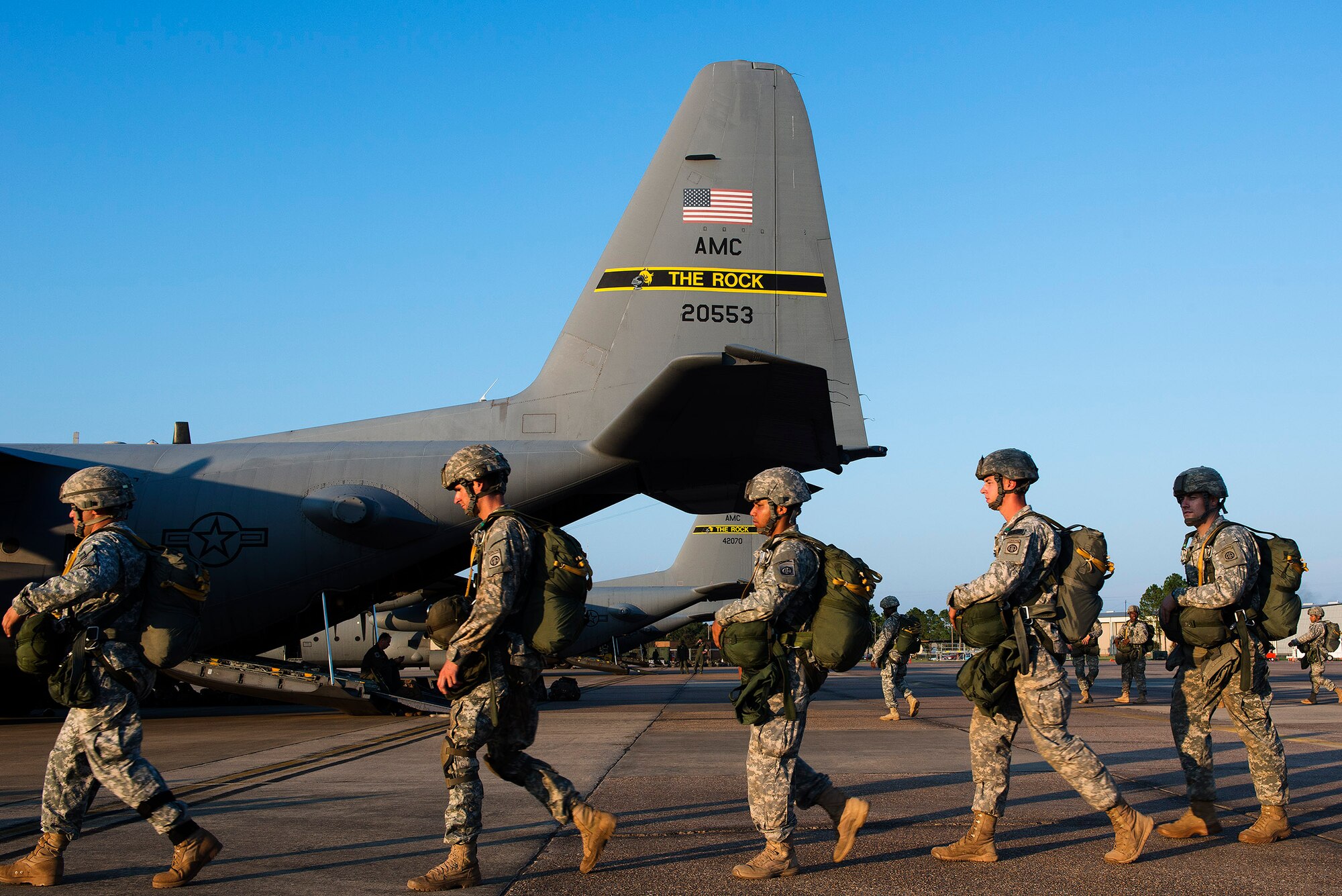 U.S. Army paratroopers from the 82nd Airborne Division step to a C-130H Aug. 18, 2013, at Alexandria International Airport, La. The paratroopers were conducting a static line drop that marked the beginning of Joint Operational Access Exercise 13-0X. (U.S. Air Force photo by Staff Sgt. Russ Scalf)