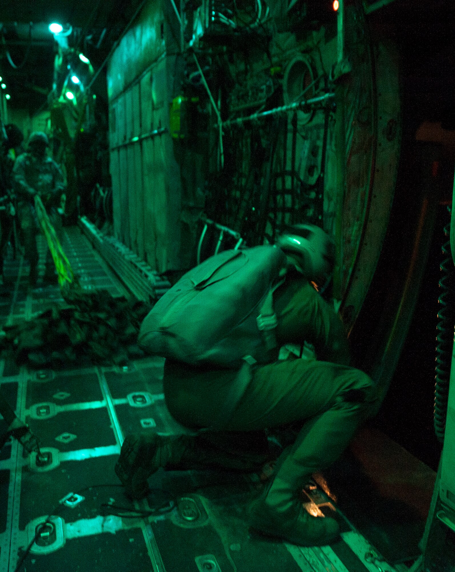 U.S Air Force Senior Airman Justin Lyles secures the aft paratroop doors of a C-130H after a personnel drop Aug. 18, 2013, near Alexandria International Airport, La. There were 681 paratroopers dropped from nine U.S. Air Force aircraft in support of Joint Operational Access Exercise 13-0X. (U.S. Air Force photo by Staff Sgt. Russ Scalf)