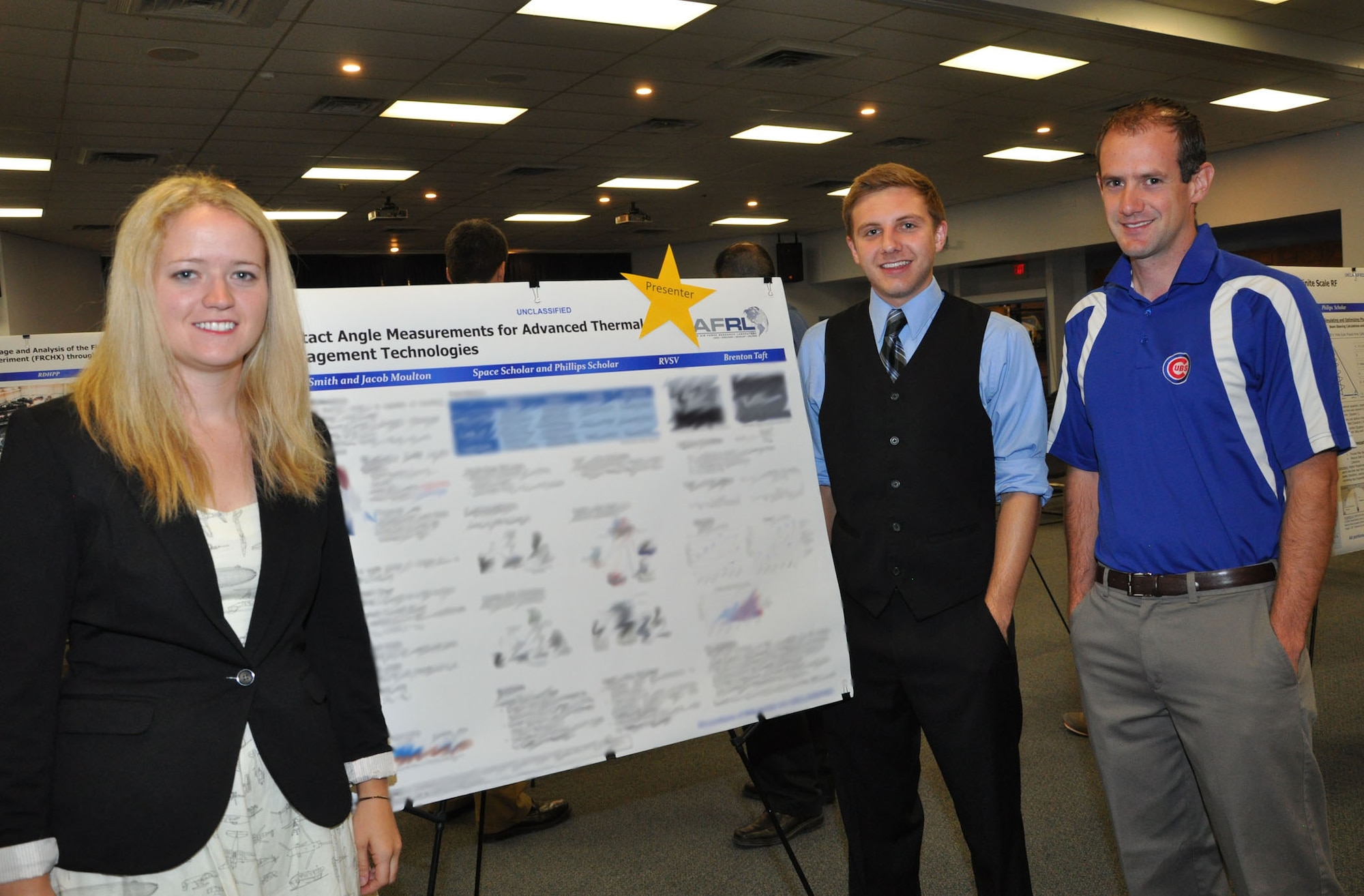 Air Force Research Laboratory Scholar Sally Smith, left, and Phillips Scholar Jacob Moulton, center, at the AFRL Scholars July poster session with their mentor, AFRL scientist Brent Taft. Smith and Moulton were amoung several students presented with awards. (Courtesy photo)