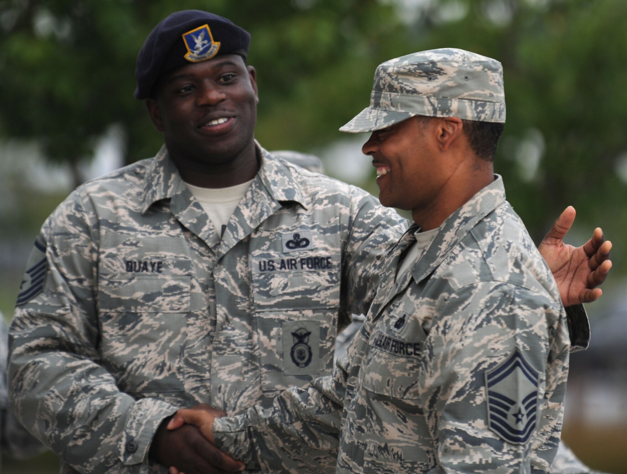 Master Sgt. Calvin Quaye, an Air Force District of Washington security forces current and future operations SNCO, congratulates Senior Master Sgt. Marvin Compton, AFDW command staff superintendent, on leading during his final retreat ceremony Aug. 29, 2013, before he retires this fall at Joint Base Andrews, Md. During the ceremony Compton served as the formation first sergeant. (U.S. Air Force photo by Tech. Sgt. Tammie Moore)