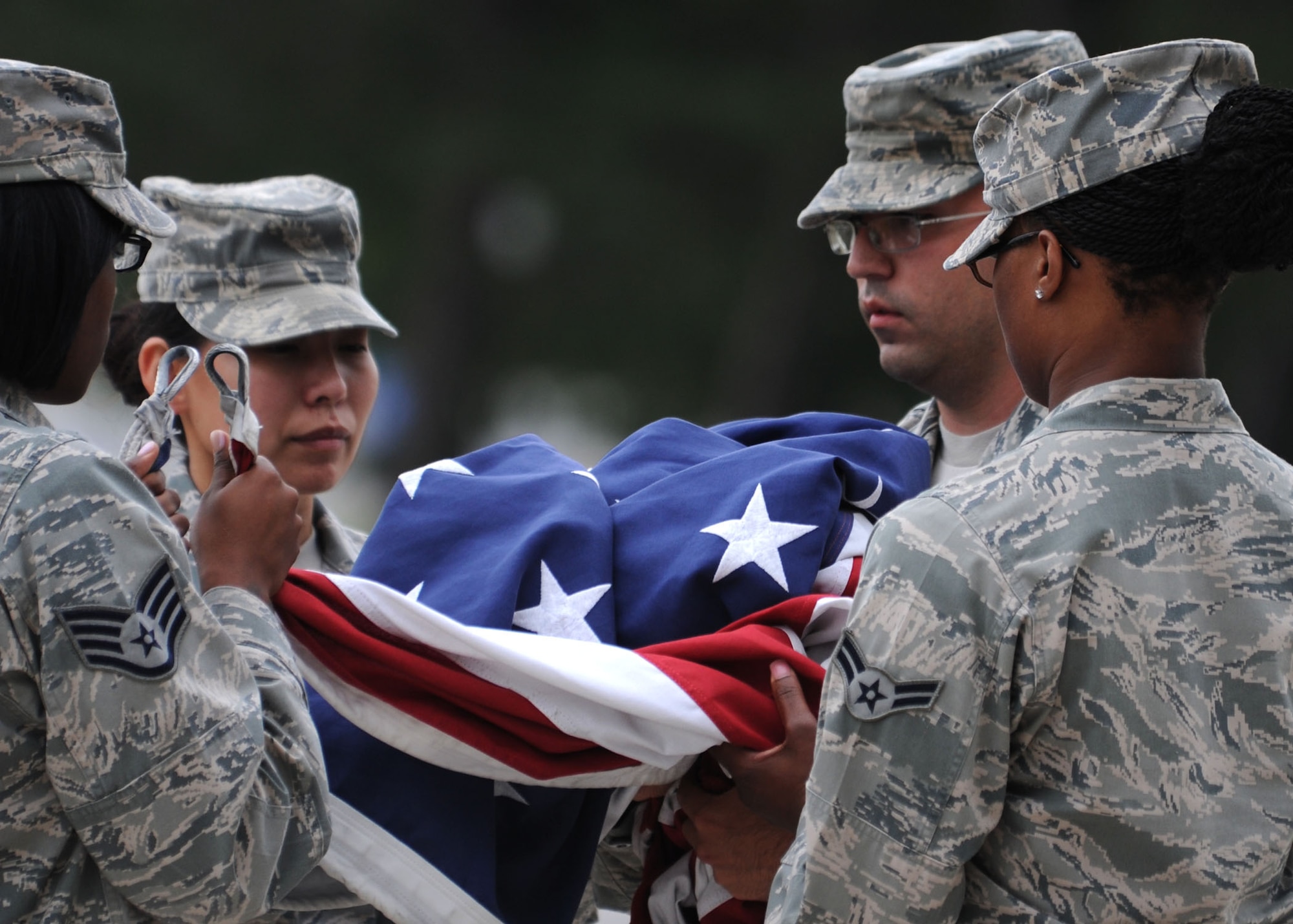 Airmen secure the flag after lowering it during the final Air Force District of Washington retreat ceremony of the year at Joint Base Andrews, Md., Aug. 29, 2013. The retreat ceremony marked the end of the duty day and paid respect to the flag. (U.S. Air Force photo by Tech. Sgt. Tammie Moore)
