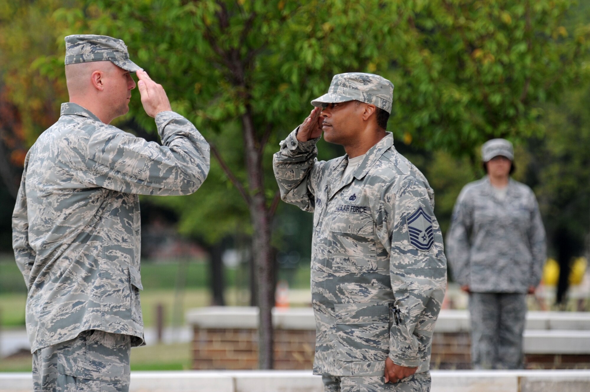 Senior Master Sgt. Marvin Compton, retreat ceremony first sergeant, salutes as he assumes command of his formation from Col. Michael Reiner, AFDW retreat ceremony commander, Aug. 29, 2013, at Joint Base Andrews, Md. Compton is the AFDW command staff superintendent. Reiner is the AFDW director of transformation. (U.S. Air Force photo by Tech. Sgt. Tammie Moore)