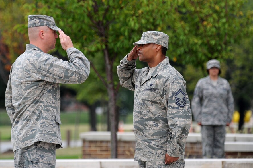 Senior Master Sgt. Marvin Compton, retreat ceremony first sergeant, salutes as he assumes command of his formation from Col. Michael Reiner, AFDW retreat ceremony commander, Aug. 29, 2013, at Joint Base Andrews, Md. Compton is the AFDW command staff superintendent. Reiner is the AFDW director of transformation. (U.S. Air Force photo by Tech. Sgt. Tammie Moore)