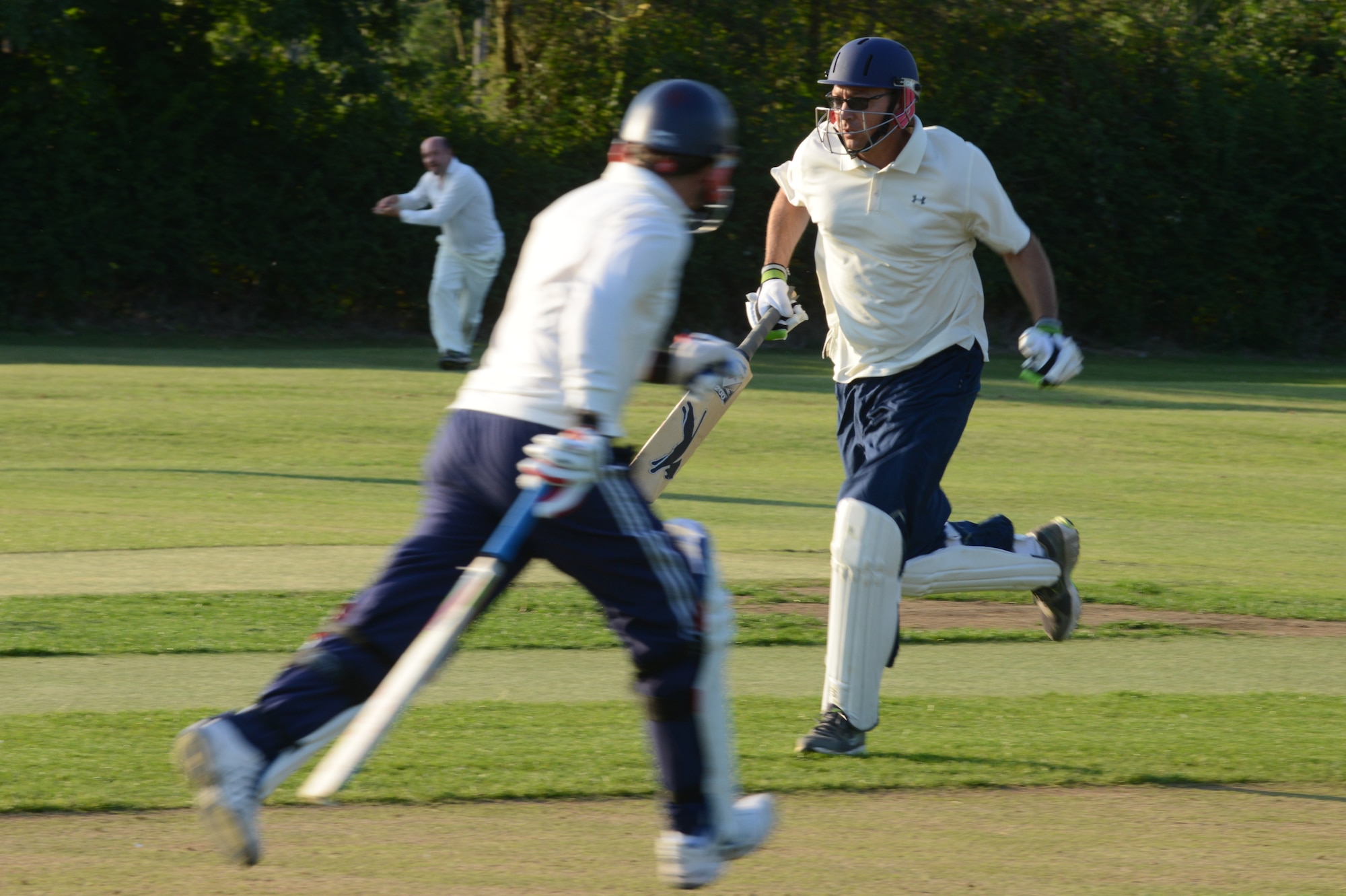 UPWOOD, United Kingdom – Lt. Col. Trevor Whitehill, , 423rd Air Base Group deputy commander, and  runs to score a run for the ABG team during the team's first game Aug. 28 at Upwood Cricket Club, Upwood, United Kingdom. If the batsman is successful in striking the ball and the ball isn’t caught before it hits the ground, the two batsmen may then try to score points (runs) for their team by running across the pitch, grounding their bats behind each other's crease. Each crossing and grounding by both batsmen is worth one run. The batsmen may attempt multiple runs or elect not to run at all. By attempting runs, the batsmen risk dismissal, which can happen if the fielding team retrieves the ball and hits a wicket with the ball before either batsman reaches the opposite crease. (U.S. Air Force photo by Tech. Sgt. Chrissy Best)