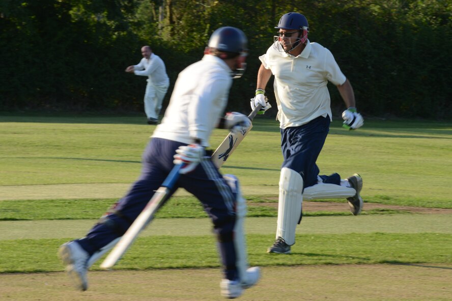 UPWOOD, United Kingdom – Lt. Col. Trevor Whitehill, , 423rd Air Base Group deputy commander, and  runs to score a run for the ABG team during the team's first game Aug. 28 at Upwood Cricket Club, Upwood, United Kingdom. If the batsman is successful in striking the ball and the ball isn’t caught before it hits the ground, the two batsmen may then try to score points (runs) for their team by running across the pitch, grounding their bats behind each other's crease. Each crossing and grounding by both batsmen is worth one run. The batsmen may attempt multiple runs or elect not to run at all. By attempting runs, the batsmen risk dismissal, which can happen if the fielding team retrieves the ball and hits a wicket with the ball before either batsman reaches the opposite crease. (U.S. Air Force photo by Tech. Sgt. Chrissy Best)
