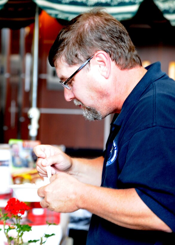 Michael Durst, Air Force District of Washington contracting operations division chief, tastes a bowl of goulash during the AFDW Food For Food Donation Lunch Festival Aug. 28, 2013, at Joint Base Andrews, Md. Indivduals were able to donate nonparishable food or make a monitary donation for their lunches to benefit Feds Feed Families during the festival. Staff members used the monetary donations to purchase additional non-perishable food for the Feds Feed Family donation drive. (U.S. Air Force photo by Tech. Sgt. Tammie Moore)