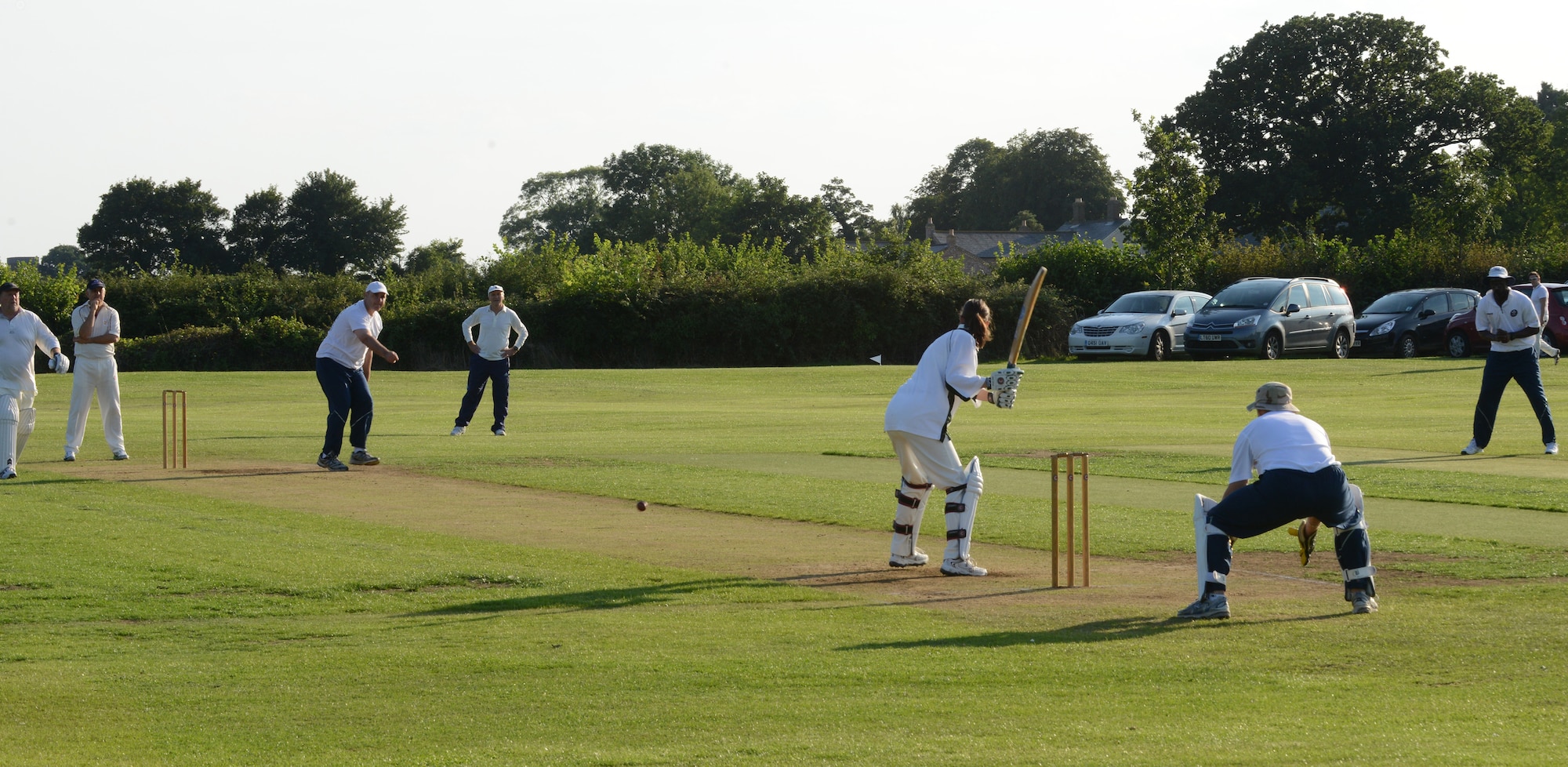 UPWOOD, United Kingdom – Col. Steven Sweeney,  , 423rd Air Base Group commander, and  bowls for the ABG team during the team's first game Aug. 28 at Upwood Cricket Club, Upwood, United Kingdom. If the batsman is successful in striking the ball and the ball isn’t caught before it hits the ground, the two batsmen may then try to score points (runs) for their team by running across the pitch, grounding their bats behind each other's crease. Each crossing and grounding by both batsmen is worth one run. The batsmen may attempt multiple runs or elect not to run at all. By attempting runs, the batsmen risk dismissal, which can happen if the fielding team retrieves the ball and hits a wicket with the ball before either batsman reaches the opposite crease. (U.S. Air Force photo by Tech. Sgt. Chrissy Best)