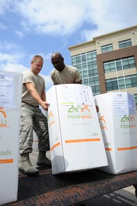 Master Sergeants Timothy Kendall and Gregory Quinn load the Food For Food Lunch donations made by Air Force District of Washington Airmen Aug. 29, 2013, in support of the Feds Feed Families campaign at Joint Base Andrews, Md. The 4,801 pounds of non-perishable food donations will be delivered to the local area food banks to help feed families in need in the National Capital Region. Kendall is the AFDW fuels manager and Quinn is an AFDW security forces current and future operations SNCO volunteering in support of the FFF program. (U.S. Air Force photo by Tech. Sgt. Tammie Moore)