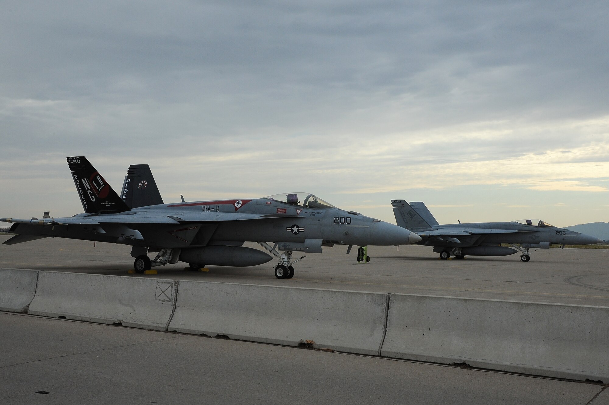 Navy F-18 Super Hornets from the Strike Fighter Squadron 14 at Naval Air Station Lemoore, Calif., sit on the flightline earlier this month at Luke Air Force Base. The F-18 pilots helped 62nd Fighter Squadron B-course students train against different aircraft beyond the F-16 they normally fly against. (U.S. Air Force photo/Airman 1st Class James Hensley)