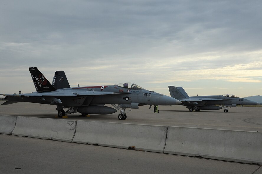 Navy F-18 Super Hornets from the Strike Fighter Squadron 14 at Naval Air Station Lemoore, Calif., sit on the flightline earlier this month at Luke Air Force Base. The F-18 pilots helped 62nd Fighter Squadron B-course students train against different aircraft beyond the F-16 they normally fly against. (U.S. Air Force photo/Airman 1st Class James Hensley)