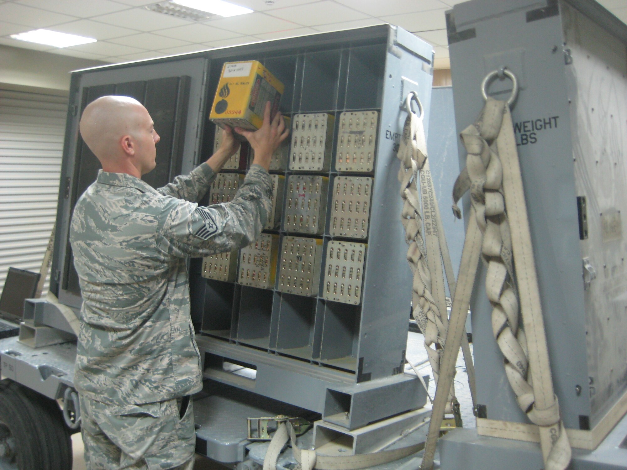 U.S. Air Force Staff Sgt. Joseph Hausman, 509th Munitions Squadron conventional maintenance crew chief, works as an ammo troop with the 386th Expeditionary Maintenance Squadron while deployed to Southeast Asia, Aug. 17, 2013. Hausman works in numerous munitions areas while deployed and recently won NCO of the month. (Courtesy photo)