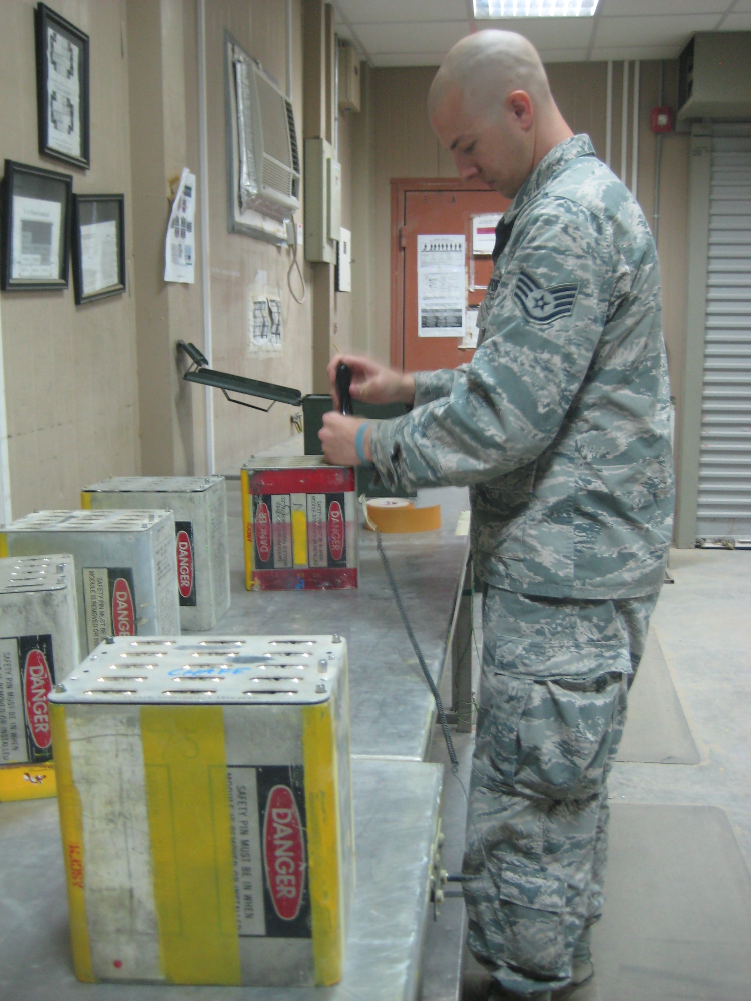 U.S. Air Force Staff Sgt. Joseph Hausman, 509th Munitions Squadron conventional maintenance crew chief, works as an ammo troop with the 386th Expeditionary Maintenance Squadron while deployed to Southeast Asia, Aug. 17, 2013. Hausman deployed in April and is expected to return in October of this year. (Courtesy photo)