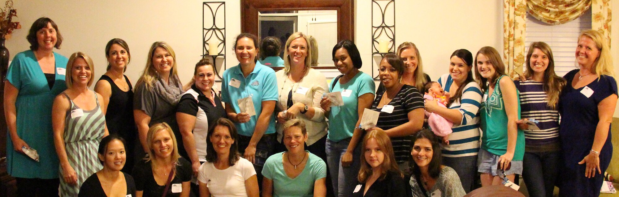 Members of the Whiteman Officer Spouse’s Club pose for a photo at the August spouses social, at Whiteman Air Force Base, Mo., August 9, 2013. The Spouses clubs fully run the base Thrift Store and Airman’s Attic. Profits from the Thrift Store are used to donate to charities and offer scholarships. (Courtesy Photo)