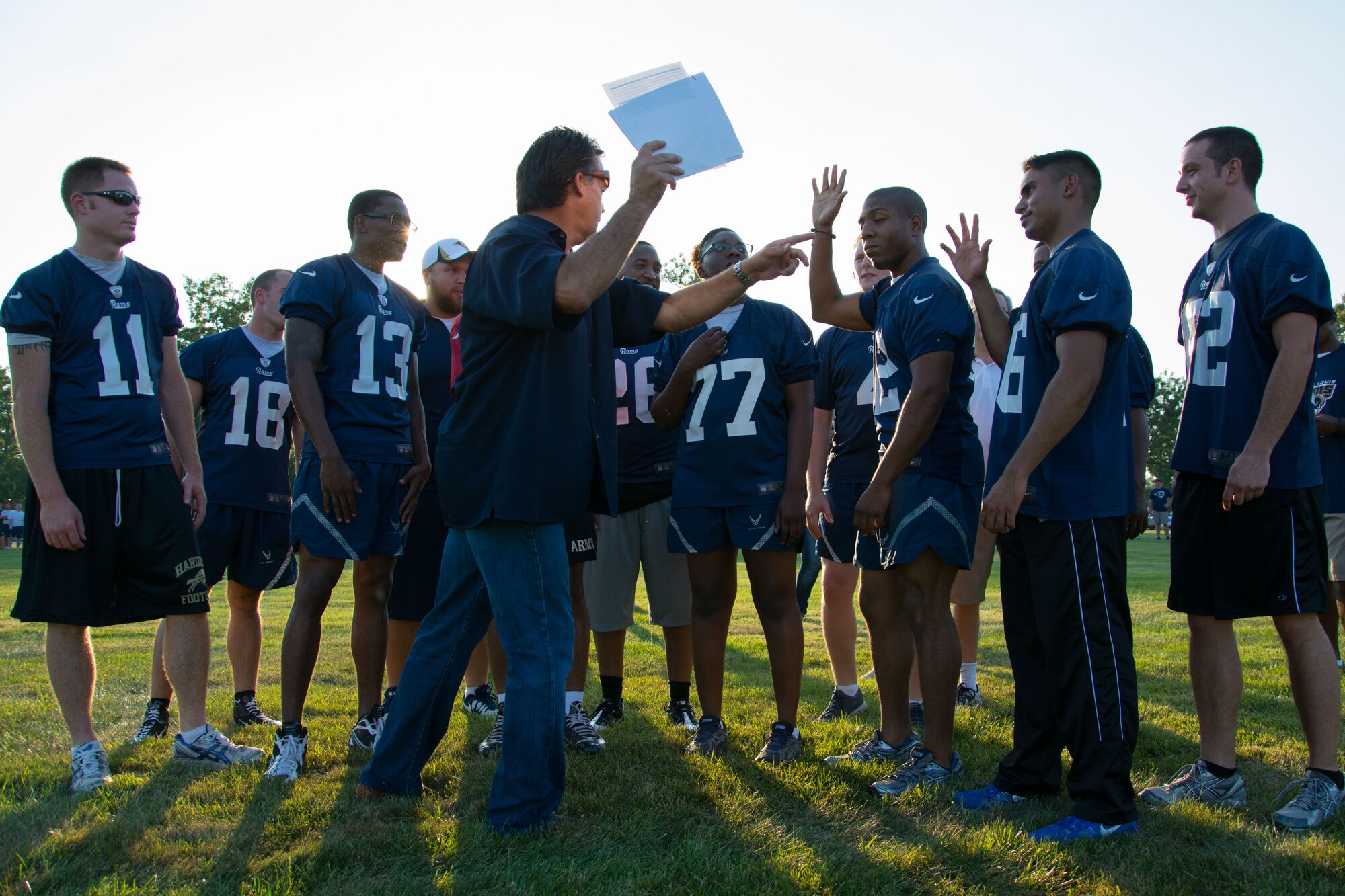 Coach Jeff Fisher outlines a play for a team of Airmen during the St. Louis Rams visit to Scott Air Force Base, Ill., Aug. 28, 2013. The Rams did offensive and defensive scrimages with a team of Airmen as well as a team of children. Fisher is the head coach for the Rams. (U.S. Air Force photo/Staff Sgt. Jonathan Fowler)