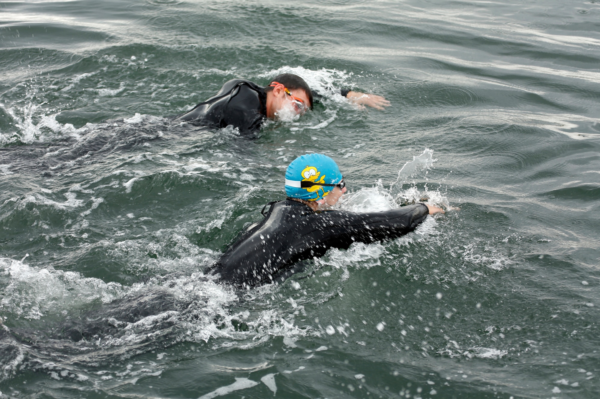 Airman 1st Class Alan Hegarty, 62nd Aerial Port Squadron passenger service representative, swims alongside a Canadian participant during this year’s Josh Fueston Memorial Swim to Live event, Aug. 25, 2013, in Bellingham, Wash. In order to help raise awareness and honor those that have been affected by post-traumatic stress disorder, 16 participants from both the U.S. and Canada swam in the event. (U.S. Air Force photo/Capt. Rachel Ianacone)