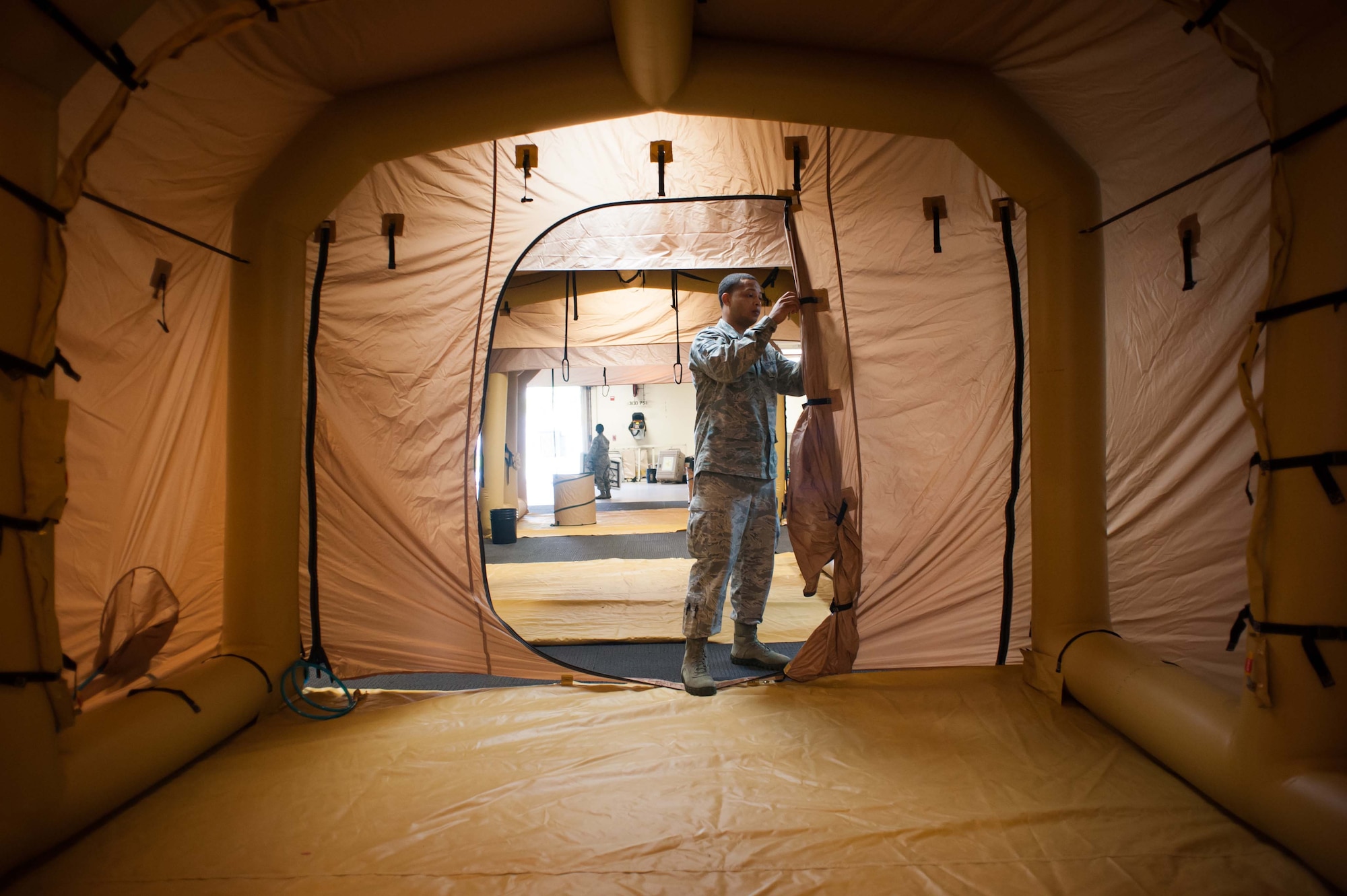 Staff Sgt. Tralves Sowell, 305th Operations Support Squadron aircrew flight equipment craftsman, sets up the Lightweight Decontamination System Aug. 16, 2013, on Joint Base McGuire-Dix-Lakehurst, N.J. The mission of the 305th OSS is to provide information, support, and equipment to allow aircrews to accomplish their global mobility mission. (U.S. Air Force photo by Russ Meseroll/Released)