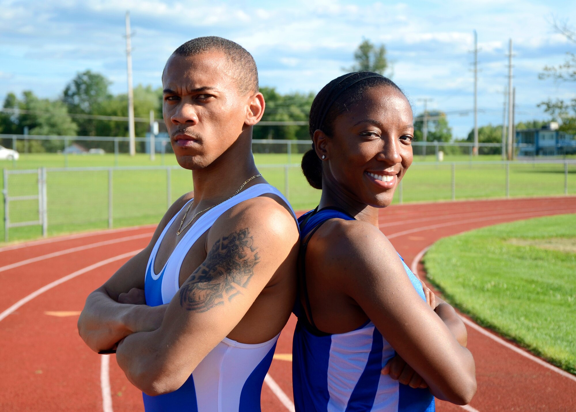 Senior Airman Alvin Jones II, 87th Comptroller Squadron travel pay technician, and Tech. Sgt. Charity Barrett, Defense Courier Service-McGuire courier, pose for a photo at Fort Dix High School Track at Joint Base McGuire-Dix-Lakehurst, N.J.  Both Airmen were selected to represent the U.S. Air Force during the 2013 Allied Air Forces Athletic Championships in Munich Germany.  Other air forces participating in the event are England, Poland, Netherlands, Germany and Belgium. (U.S. Air Force photo by Tech. Sgt. Charity Barrett/Released)