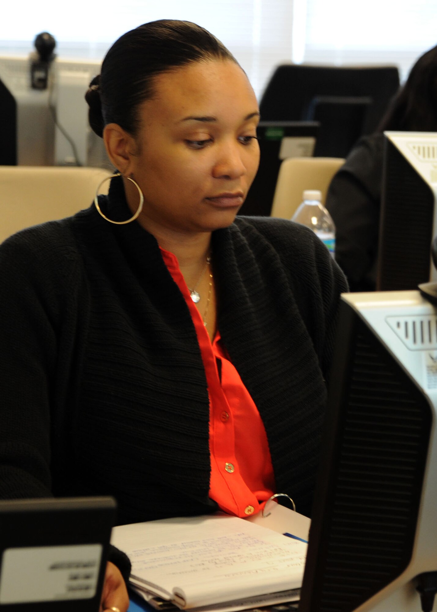 Natosha Allen, Air Force District of Washington contracting intern, refers to the Internet during a New Intern Boot Camp class Aug. 27, 2013, at Joint Base Andrews, Md. The class provided AFDW contracting interns with an understanding of the request for proposal and solicitation process.  (U.S. Air Force photo by Tech. Sgt. Tammie Moore)