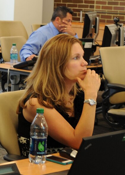 Erin Fisher, Air Force District of Washington contracting specialist, listens to instruction during a New Intern Boot Camp class Aug. 27, 2013, at Joint Base Andrews, Md. The class is part of a series contracting interns attend here to gain an understanding of terminology and forms used in Air Force contracting. (U.S. Air Force photo by Tech. Sgt. Tammie Moore)