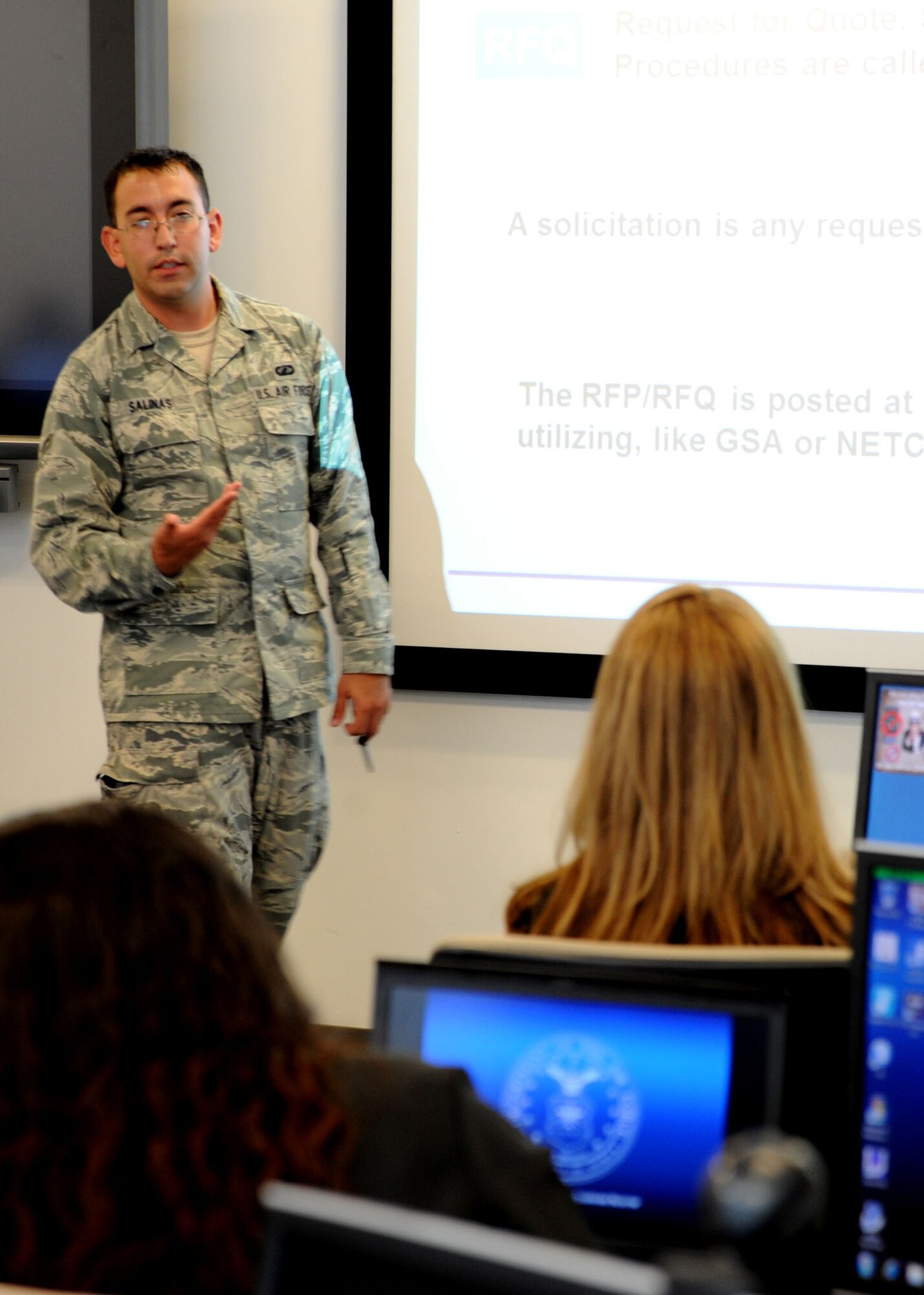 Airman 1st Class Christian Salinas, Air Force District of Washington contracting specialist, teaches a New Intern Boot Camp class Aug. 27, 2013, at Joint Base Andrews, Md. Salinas is instructing the class of contracting interns about the Air Force request for proposal and solicitation process. (U.S. Air Force photo by Tech. Sgt. Tammie Moore)