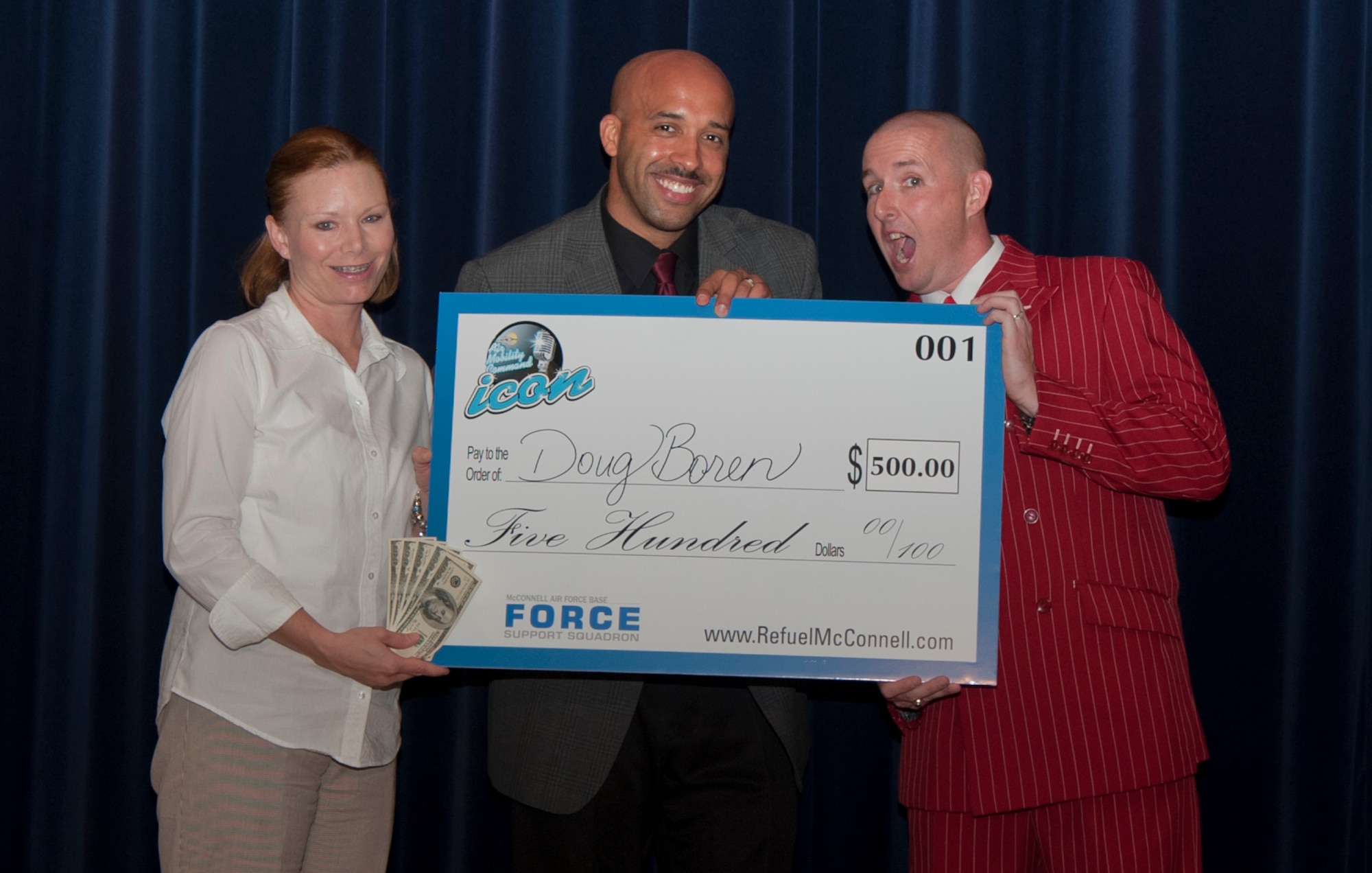 (Right) Tech. Sgt. Doug Boren, 384th Air Refueling Squadron instructor boom operator, receives a check for $500 from Lt. Col. Dianne Ferrarini, 22nd Force Support Squadron commander and Tech. Sgt. Terrance Williams, 22nd Air Refueling Wing Honor Guard NCO in charge Aug. 24, 2013, at McConnell Air Force Base, Kan. Boren took first place in this year’s McConnell Icon singing competition. Air Force wide contestants competed for a chance to move to the next round at Scott AFB, Ill. (U.S. Air Force photo/Airman 1st Class Colby L. Hardin)