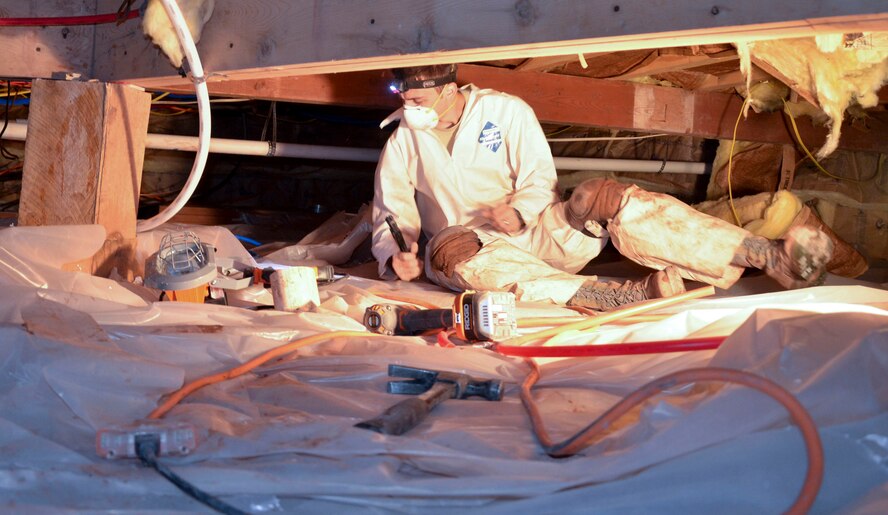 Missouri Air National Guard Senior Airman Jared Beasley, 131st Civil Engineer Squadron utility technician, installs plumbing in the crawl-space below the “hogans,” or Navajo buildings, at St. Michaels Academy in Window Rock, Ariz., Aug. 8, 2013. Members of the 131st Civil Engineer Squadron were sent to Arizona in two-week intervals to help make renovations and provide construction for the Navajo nation. (U.S. Air Force photo/Released)