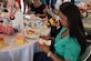 Tech Sgt. Jessica Feliciano, of the 817th Global Mobility Readiness Squadron, opens a pair of earrings given to her and the rest of the military mom's honored at Operation Shower held at the Barclay golf course August 21, 2013, in Jersey City, N.J. Operation Shower is a non-profit organization that hosts baby showers for military mothers-to-be to ease the stress of deployment. (U.S. Army photo by Cpl. Mariah F. Best/Released)