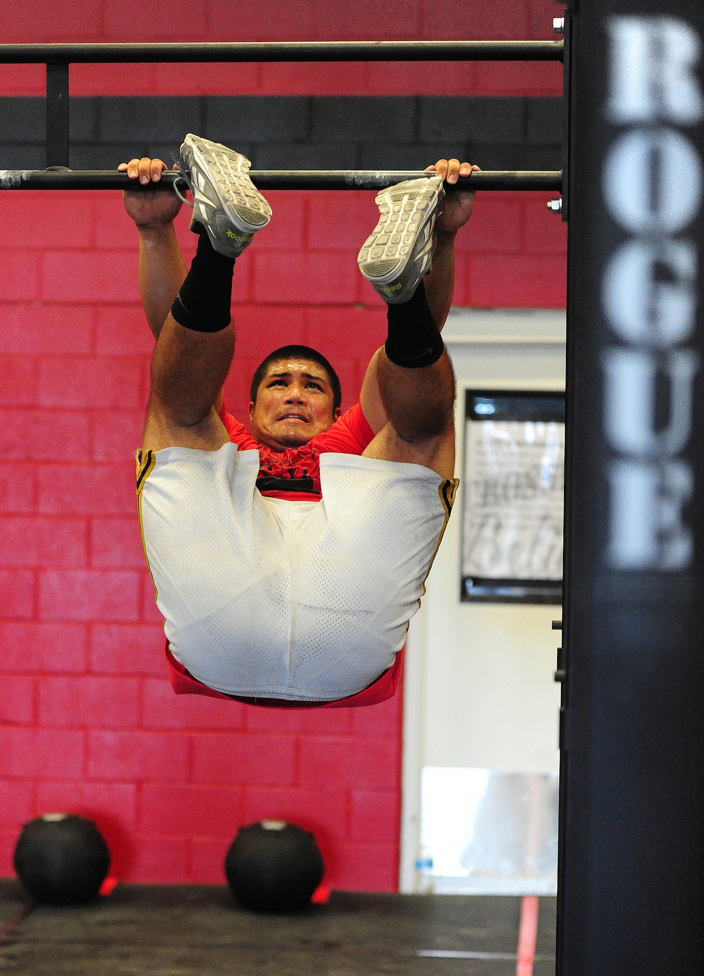 Gerald Cawelti, a U.S. Air Force Officer Training School prospect, performs a “toes to bar” exercise at a competition at the CrossFit Believe gym in Warrensburg, Mo., Aug. 8, 2013. Cawelti recently graduated from the University of Central Missouri with a major in history and a minor in world languages and customs. He is currently awaiting results from his Air Force Officer Qualifying Test and hopes to soon earn a commission. (U.S. Air Force photo by Staff Sgt. Nick Wilson/Released) 