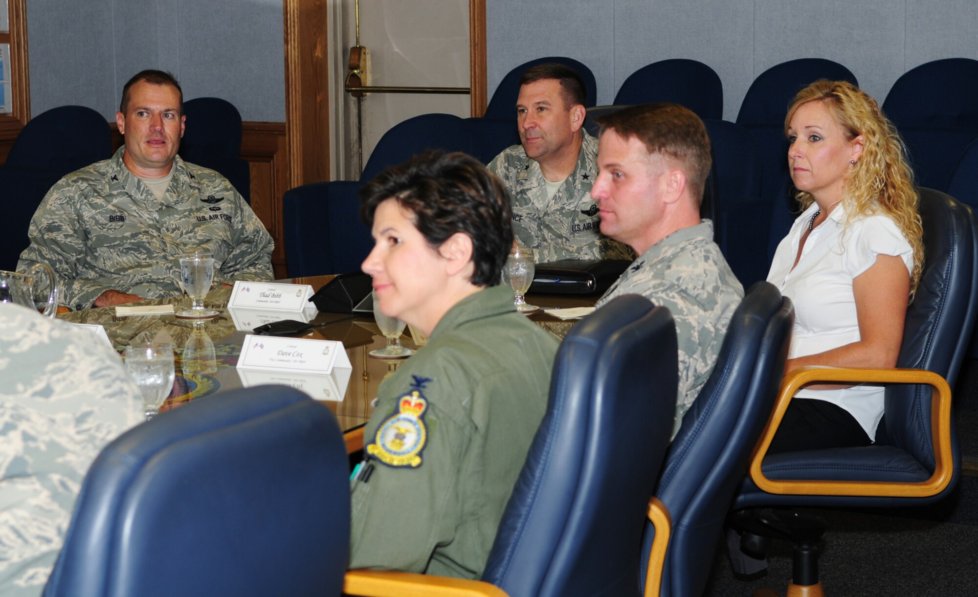 U.S. Air Force Brig. Gen. Christopher Bence, center, U.S. Air Forces in Europe-UK director, and his wife Wendy, right, receive a mission briefing from U.S. Air Force Col. Kenneth T. Bibb Jr., left, 100th Air Refueling Wing commander, and other 100th ARW leadership Aug. 28, 2013, during an immersion of the 100th ARW on RAF Mildenhall, England. The general's visit also included stops at the 100th Operations Support Squadron Air Traffic Control Tower, 100th Civil Engineer Squadron Fire Department and 100th Maintenance Group. Bence, who has been stationed at RAF Mildenhall since July, is the designated U.S. country representative to the United Kingdom for European Command and USAFE, providing military liaison to Her Majesty's Government. (U.S. Air Force photo by Karen Abeyasekere/Released)