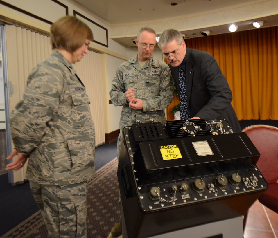 Col. Michael Kelly, Electronic Warfare and Avionics Division chief and John Miller, Agile Combat Support director, view a Joint Service Electronic Combat Systems Tester Tuesday during a reception at the Horizons Event Center. (U.S. Air Force photo by Tommie Horton)
