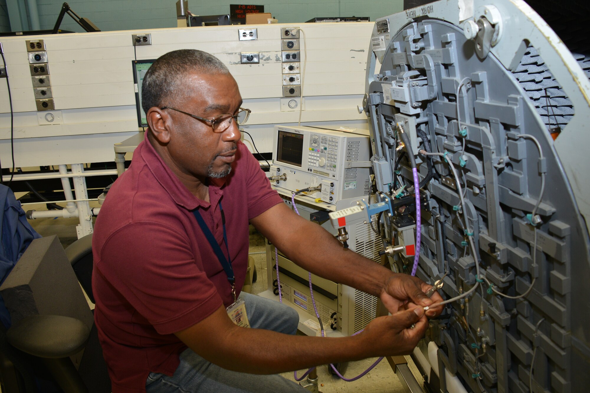 Alfred Harris, 568th Electronic Maintenance Group F-15 radar electronics technician,  performs maintenance on F-15 radar antennas. 566th EMXS performs and overhauls the B-52 radar systems. This work is just one way Team Robins members provide Global Vigilance, Global Reach and Global Power for America. (U.S. Fir Force photo by Edward Aspera)