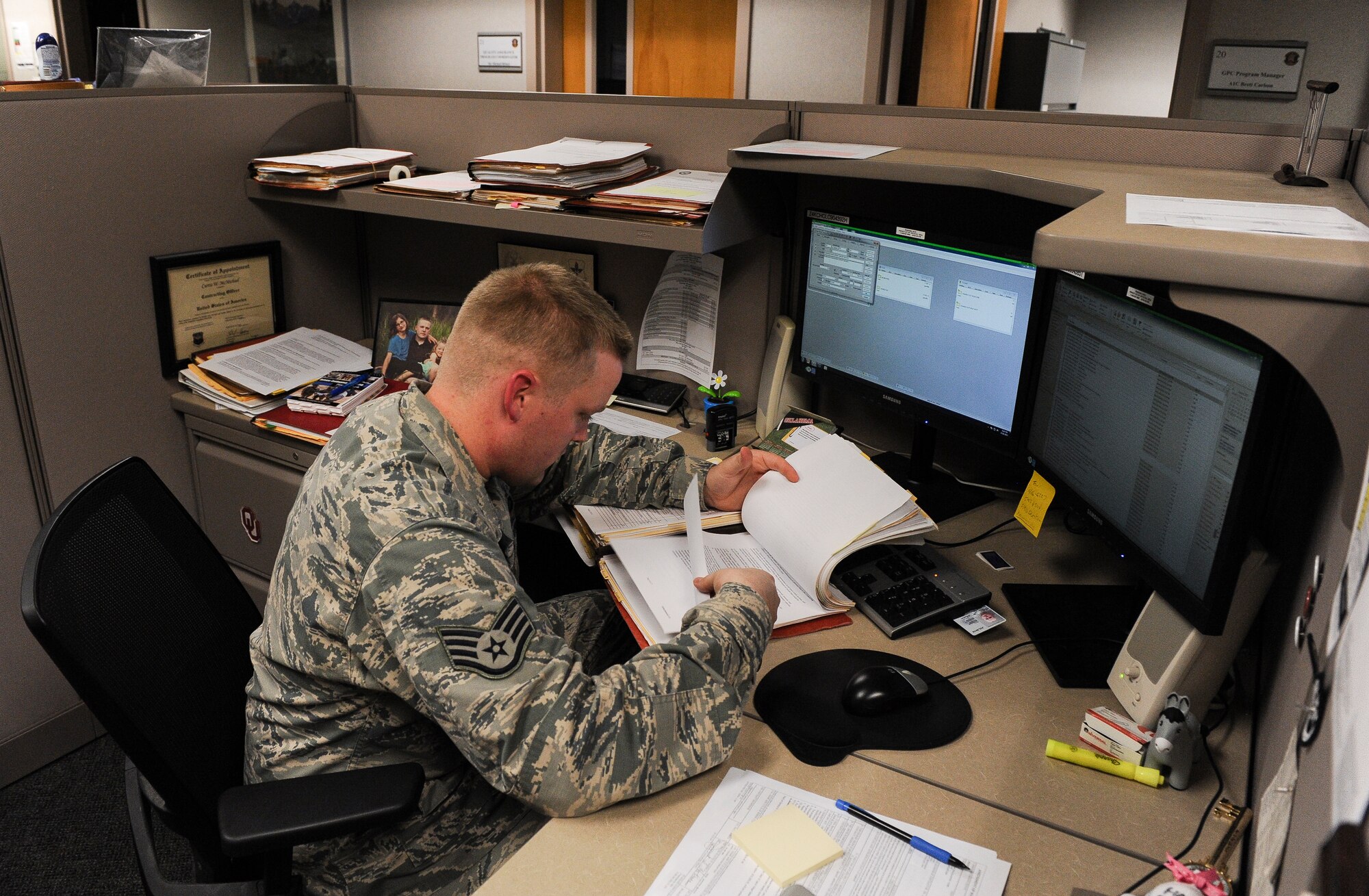 Staff Sgt. Curtis McMichael, a 19th Contracting Squadron contracting specialist, reviews a contract Aug. 26, 2013, at Little Rock Air Force Base, Ark. McMichael, a Tulsa, Okla., native, also serves as his squadron’s Operations Security manager, ensuring complete squadron compliance with OPSEC regulations.(U.S. Air Force photo by Staff Sgt. Jake Barreiro)