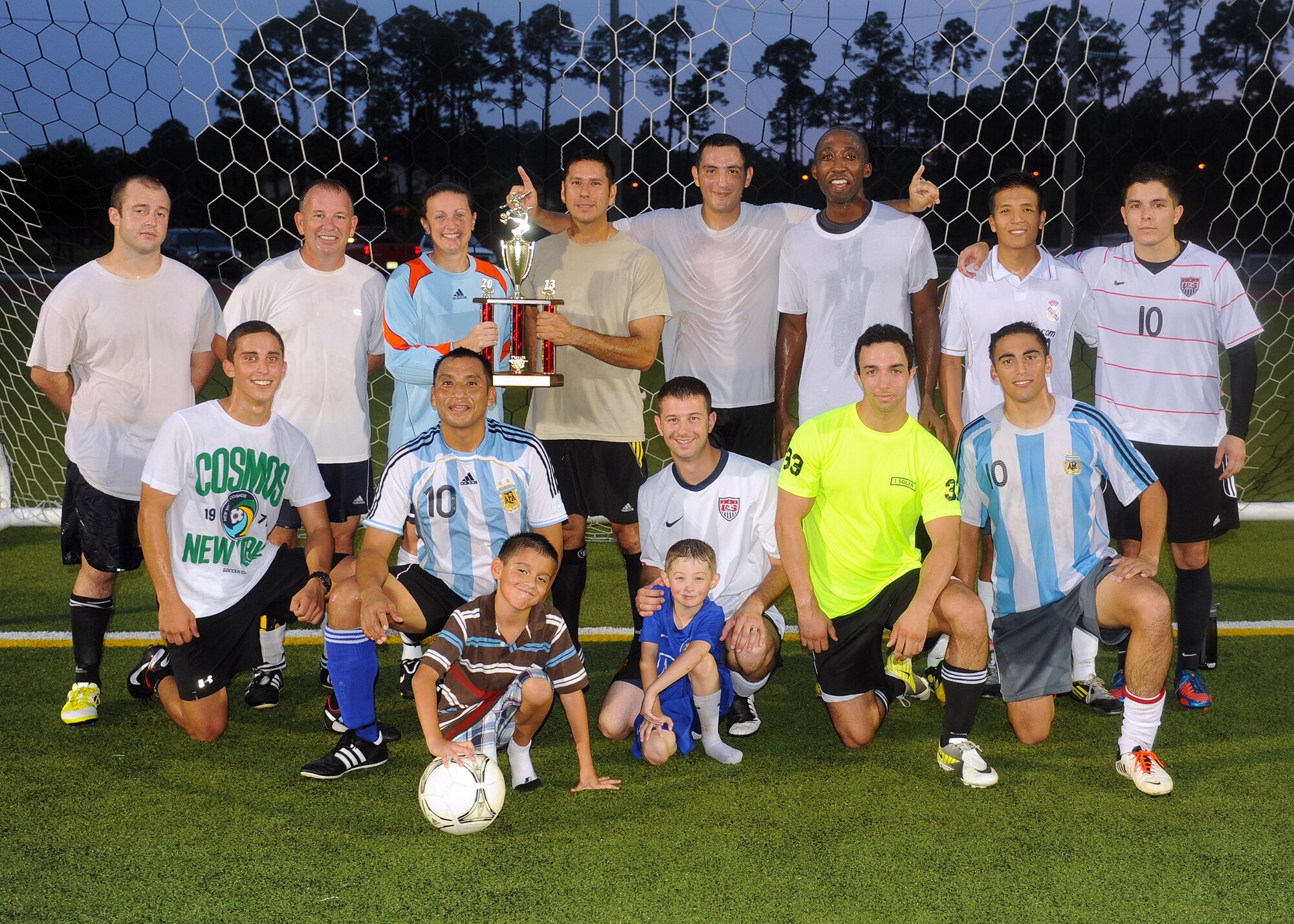 The 9th Special Operations Squadron soccer team, poses for pictures with their newly awarded trophy after winning the 2013 Hurlburt Field Intramural Soccer Playoffs at the Alderholt gym on Hurlburt Field, Fla., Aug. 16. 16 teams, composed of various units on Hurlburt, competed in the tournament, making it one of the most participated in sporting events of the year for the base. (U.S. Air Force photo/Senior Airman Kentavist P. Brackin) 