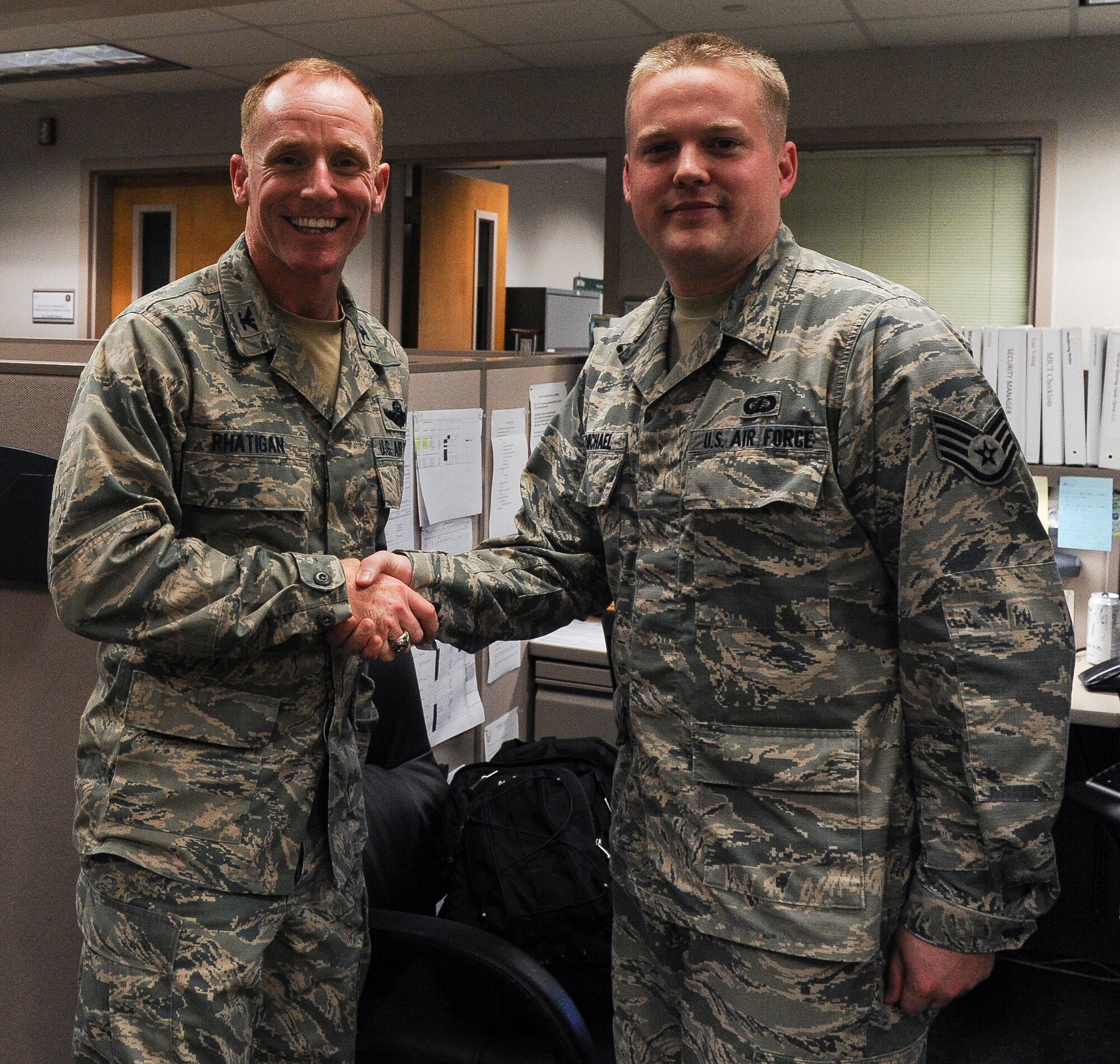 Staff Sgt. Curtis McMichael, a 19th Contracting Squadron contracting specialist, receives a commander’s coin from Col. Patrick Rhatigan, 19th Airlift Wing commander, for his selection as Combat Airlifter of the Week Aug. 26, 2013, at Little Rock Air Force Base, Ark. McMichael led the inspection of more than $9 million in service contracts, identifying problem areas in his office en route to ensuring 100 percent compliance. (U.S. Air Force photo by Staff Sgt. Jake Barreiro)