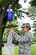 Airman 1st Class Jacqueline Douglas, 87th Aerospace Medicine Squadron Public Health Flight technician, places a N.J. light mosquito trap on a tree Aug. 19, 2013, at Joint Base McGuire-Dix-Lakehurst, N.J. The Airmen set up 12 traps across the base, geographically separated to yield the most diverse sample batch in order to prevent the joint base populous from suffering from diseases. (U.S. Air Force photo by Airman 1st Class Ryan Throneberry/Released)