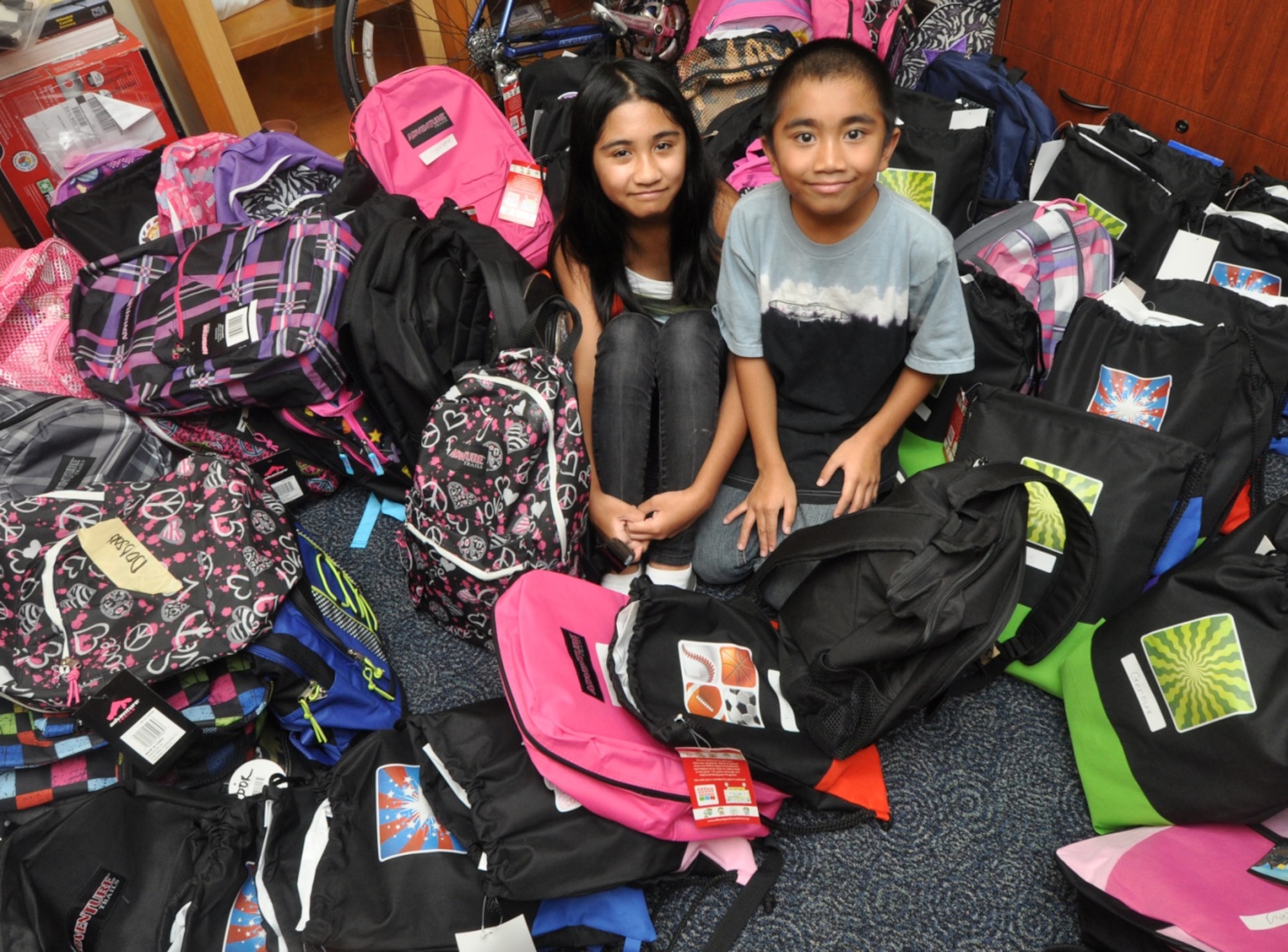 Kristal and Kristoffer Nicholas were all smiles as they received backpacks full of supplies on Aug. 19. Backpacks were provided through the Back-To-School Brigade.