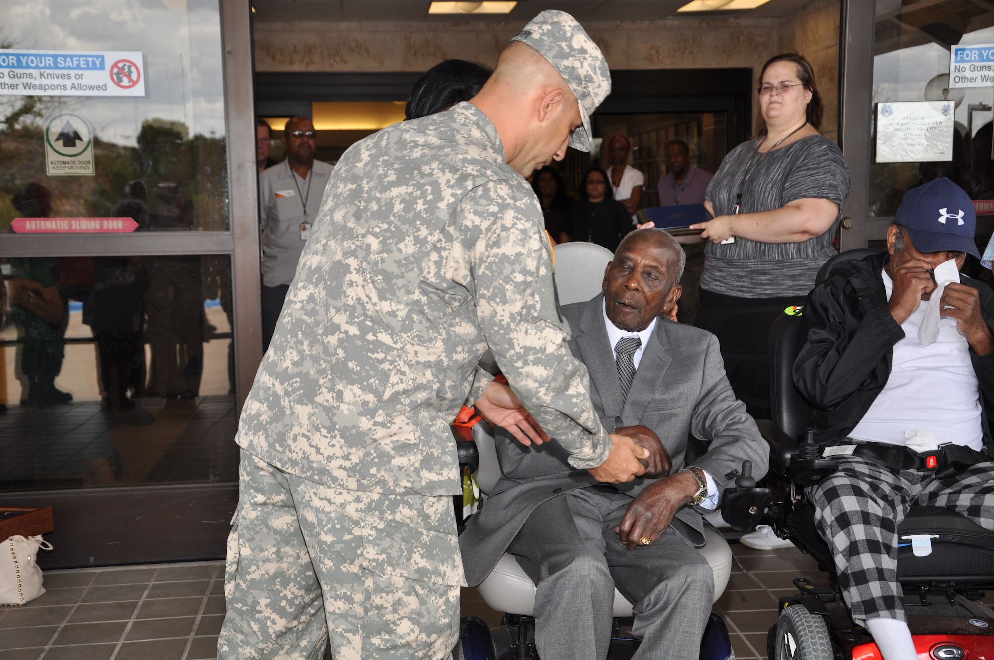 BIG SPRING, Texas- Army Command Sgt. Maj. Matt Coppi, 344th Military Intelligence Battalion command sergeant major, presents Otho Henry, World War II Army veteran, with a coin for his 100th birthday at the West Texas Veterans’ Affairs Health Care System Facility Aug. 23. Henry participated in the D-Day landing in France and later fought in the Battle of the Bulge.  (U.S. Air Force photo/ Airman 1st Class Erica Rodriguez)
