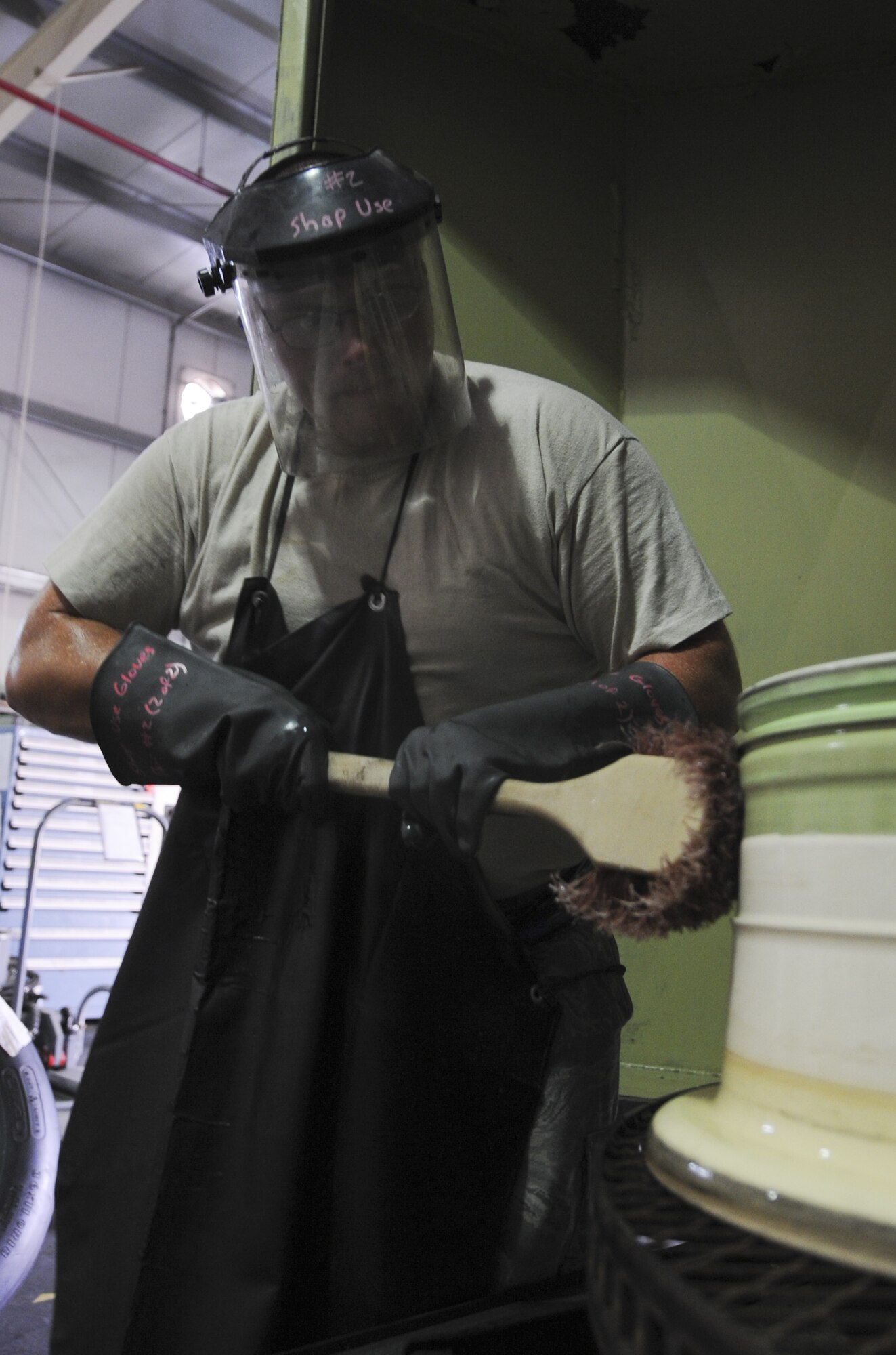 U.S. Air Force Staff Sgt. Aaron Larson, 380th Expeditionary Maintenance Squadron Crash Recovery craftsman, scrubs grease off an aircraft’s wheels at an undisclosed location in Southwest Asia Aug. 26, 2013. Larson is scrubbing the grease before it goes into a machine designed to completely clean the wheel for inspection. Larson calls Alpena, Mich., home and is deployed from Mountain Home Air Force Base, Idaho. (U.S. Air Force photo by Staff Sgt. Jacob Morgan)