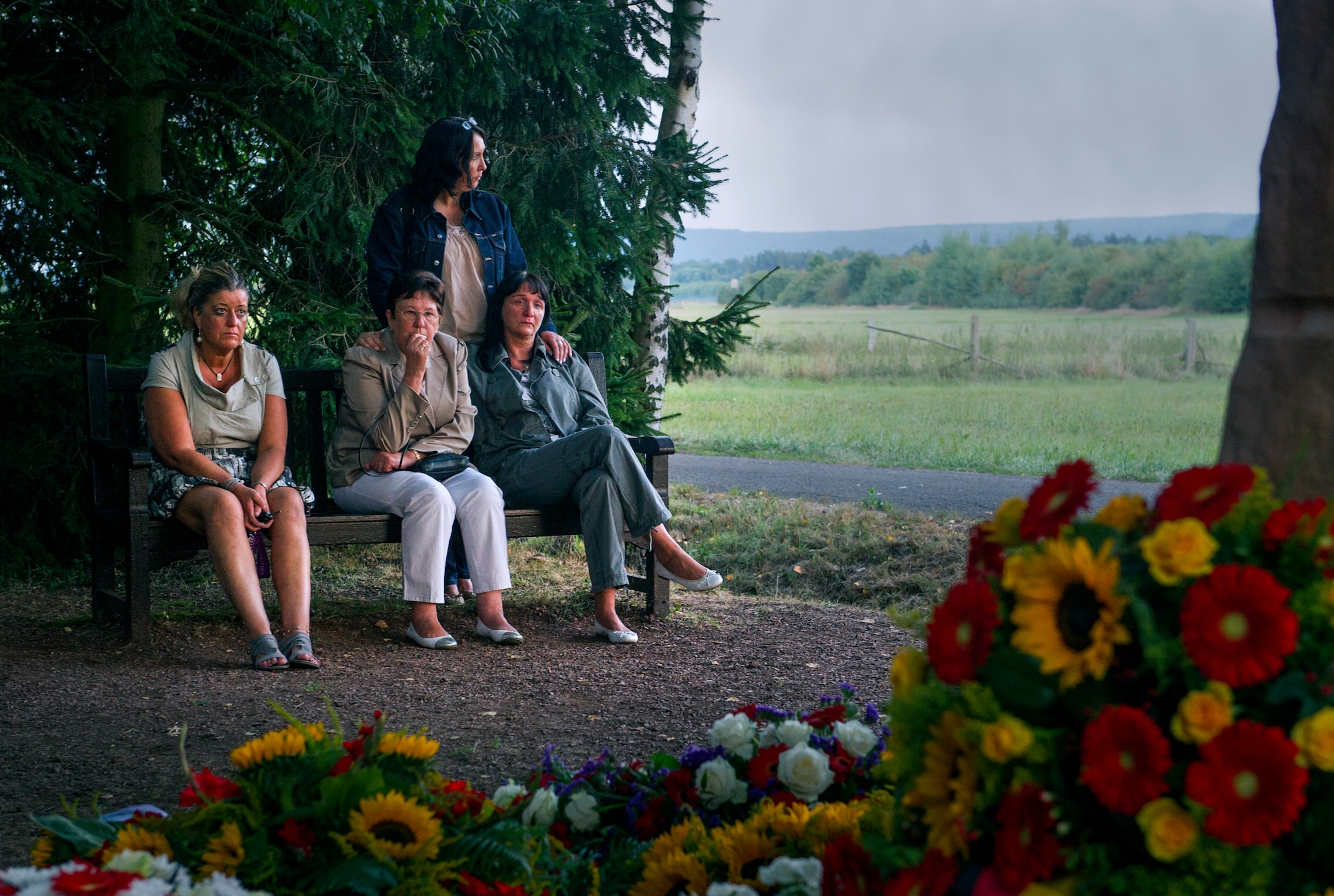 RAMSTEIN, Germany -- Mourners pay their respects at the memorial site of the 1988 Ramstein air show disaster, Aug. 28, 2013. People gathered on the 25th anniversary of the disaster to remember the 70 people who died when and Italian aerial demonstration team crashed during the show. (U.S. Air Force photo/Tech. Sgt. Benjamin Wilson)