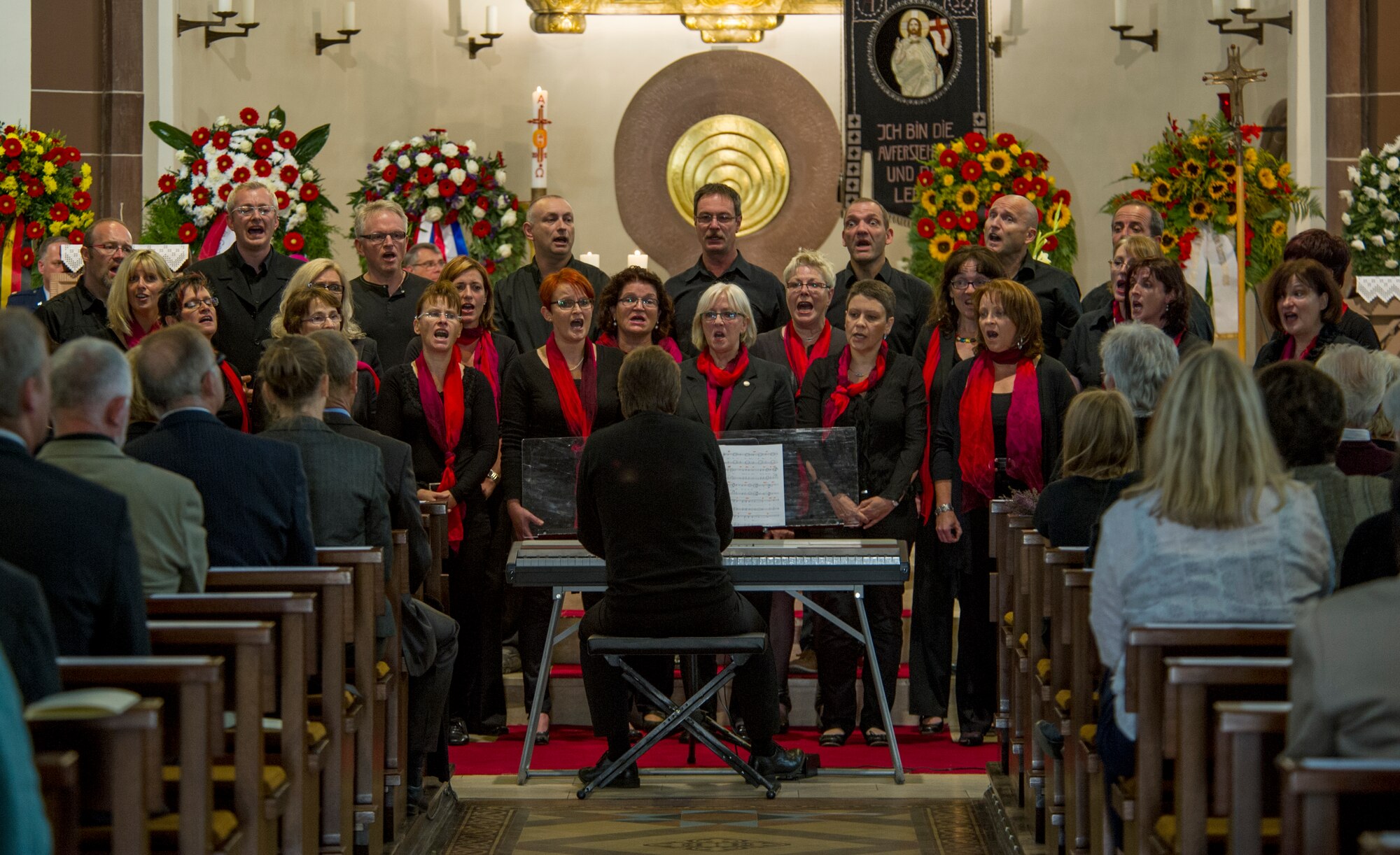 RAMSTEIN, Germany -- A gospel choir sings during a memorial service in the St. Nikolas Church for the 70 people who died in the 1988 Ramstein air show disaster, Aug. 28, 2013. The service marked the 25th anniversary of the disaster. (U.S. Air Force photo/Tech. Sgt. Benjamin Wilson)