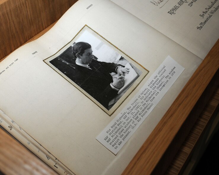 In 1982, His Royal Highness, the Prince of Wales, signed the official RAF Station Book on RAF Mildenhall, England. The cabinet housing the book had a broken piece of glass. The chapel ordered a new piece of glass, and David Spragg, 100th Civil Engineer Squadron structures charge hand carpenter and joiner from Yorkshire, England, and Airman 1st Class Scott Haeseler, 100th CES structures journeyman from Mystic, Conn., used their time and skills to make a new case out of off-cuts at no cost to the U.S. government. (U.S. Air Force photo by Gina Randall/Released)