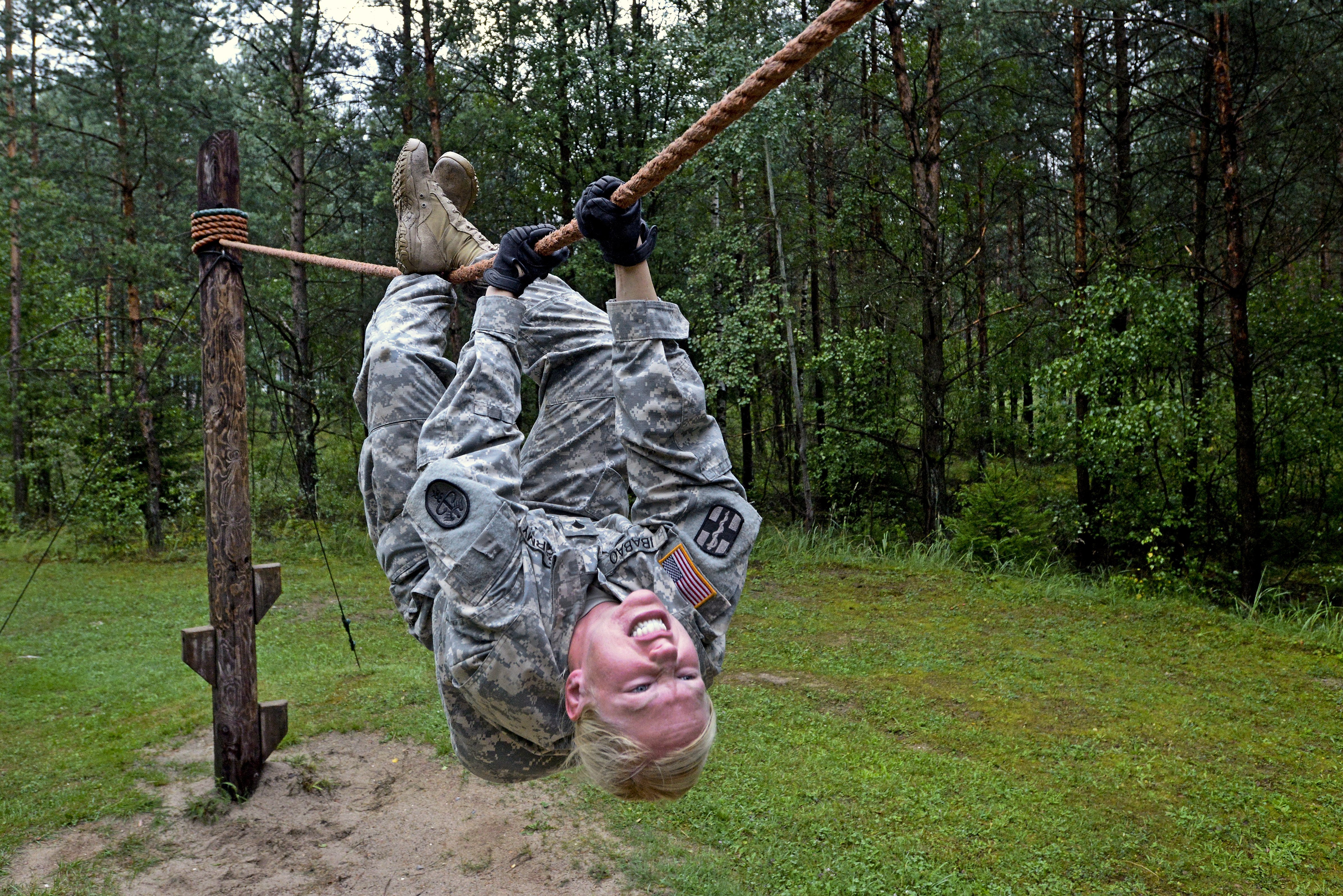 U.S. Army Spc. Elizabeth Ibabao crosses a rope bridge on the