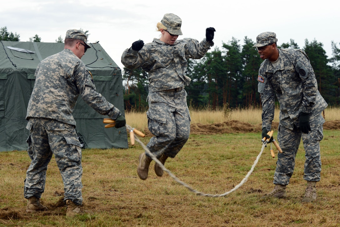U.S. Army 1st Lt. James Deacon, left, U.S. Army Sgt. Antoinio Minnifield, right, and U.S. Army Spc. Elizabeth Ibabao complete a jump rope challenge during U.S. Army Europe's Best Warrior competition in Grafenwoehr, Germany, Aug. 19, 2013. Deacon, Minnifield and Ibabao are assigned to European Regional Dental Command.