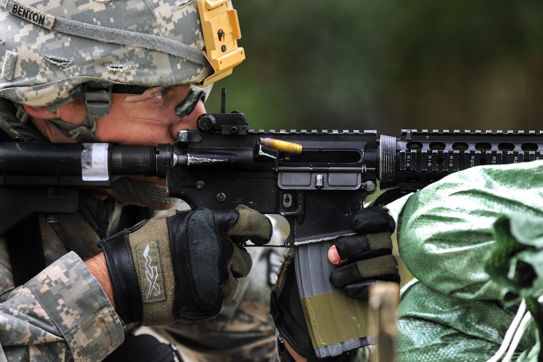 U.S. Army 2nd Lt. Beau Benton fires his M4 rifle during U.S. Army ...