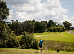 Jeff Kile, of the 53rd Wing, takes a swing at the Par 3 second hole of the base intramural golf championship Aug. 28 at the Eglin Golf Course.  The 53rd WG competed against the 36th Electronic Warfare Squadron and were tied after 18 holes.  The 36th EWS team won the sudden death playoff on the first hole to claim the championship.  (U.S. Air Force photo/Samuel King Jr.)
