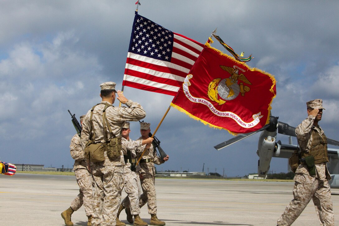 Lt. Col. Larry G. Brown salutes the Marine Medium Tiltrotor Squadron 262 unit colors as they pass in review Aug. 30 during a redesignation ceremony at Marine Corps Air Station Futenma. The squadron, previously Marine Medium Helicopter Squadron 262, was redesignated to reflect the replacement of the squadron's CH-46E Sea Knight helicopters with MV-22B Osprey tiltrotor aircraft.  The Osprey will increase the operational range, agility and load-carrying capabilities of VMM-262, providing III Marine Expeditionary Force with improved rapid-response ability throughout the Asia-Pacific region. VMM-262 is a part of Marine Aircraft Group 36, 1st Marine Aircraft Wing, III MEF.  Brown is the commanding officer of VMM-262. 