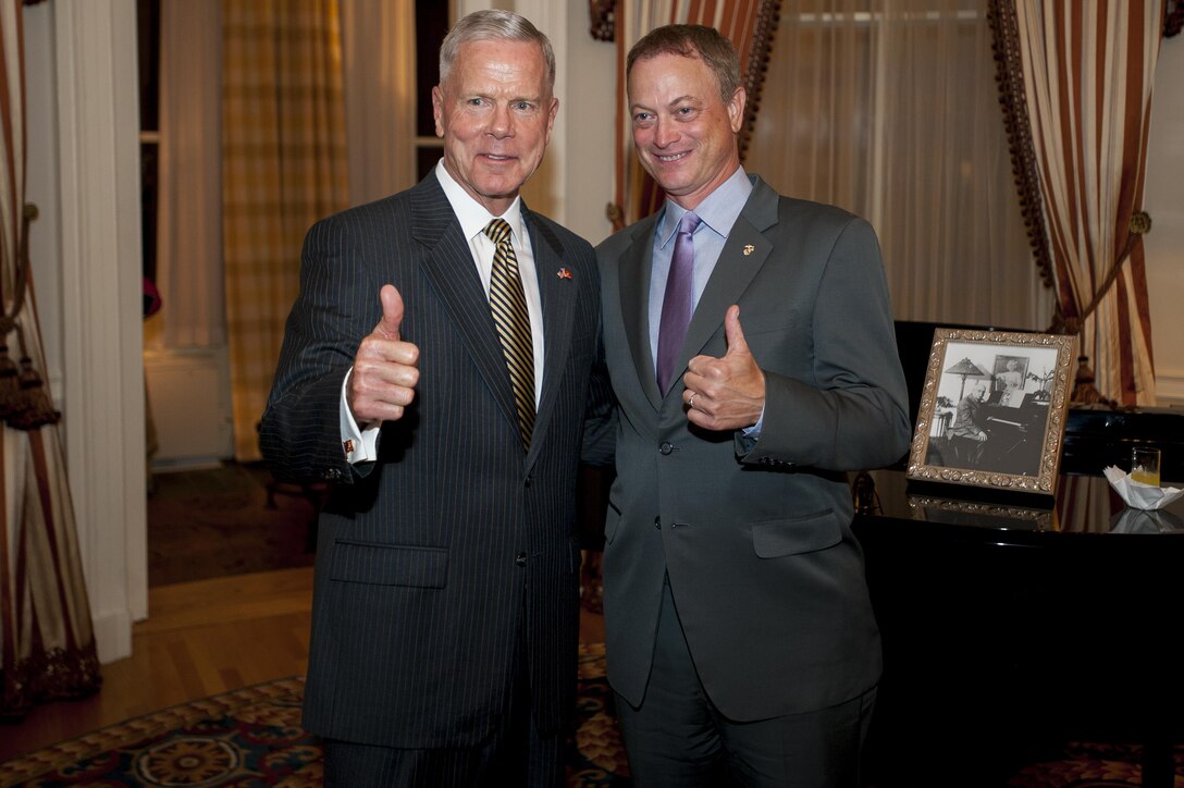 Gen. James F. Amos, commandant of the Marine Corps, and actor and musician Gary A. Sinise, pose for a picture after Sinise was named an honorary Marine at Marine Barracks Washington, D.C., Aug. 29.