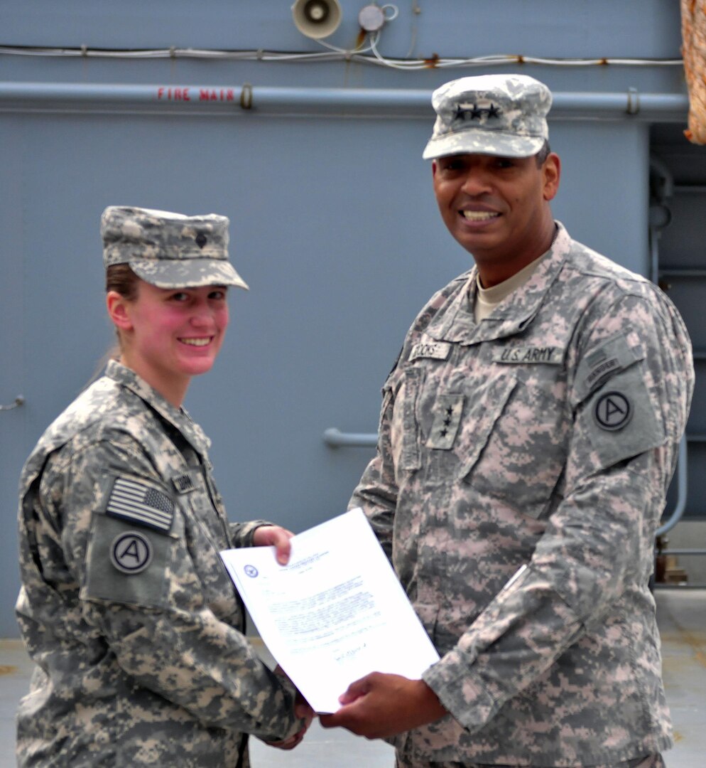 Spc. Erin Colburn receives a letter of conditional acceptance to West Point by Lt. Gen. Vincent K. Brooks, commanding general of Third Army/ARCENT.
