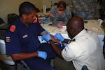 South Dakota Army National Guard Sgt. 1st Class Kelley Crane, combat lifesaver and emergency medical technician, conducts combat medical training with Soldiers from Suriname's armed forces, in Paramaribo, Suriname, Nov. 24, 2012.