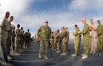 U.S. Army Spc. Lyle Yantz, of Sedalia, Mo., and several other service members participating in Operation Proper Exit are greeted at Kandahar Airfield, Afghanistan, Dec. 6, 2012. Operation Proper Exit brings severely wounded service members back to the theater where they sustained their injuries to provide a firsthand progress update on the continuing mission and to help in the healing process.